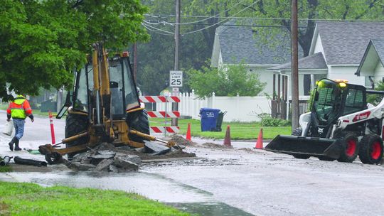 City public works personnel clean up on Monday morning after spending 17 hours repairing a water main leak on 10th Street