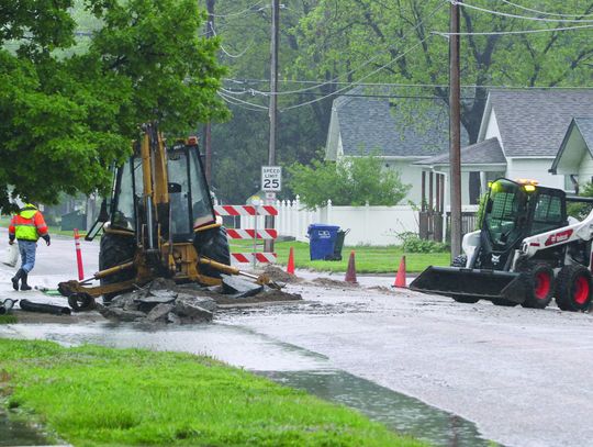 City public works personnel clean up on Monday morning after spending 17 hours repairing a water main leak on 10th Street