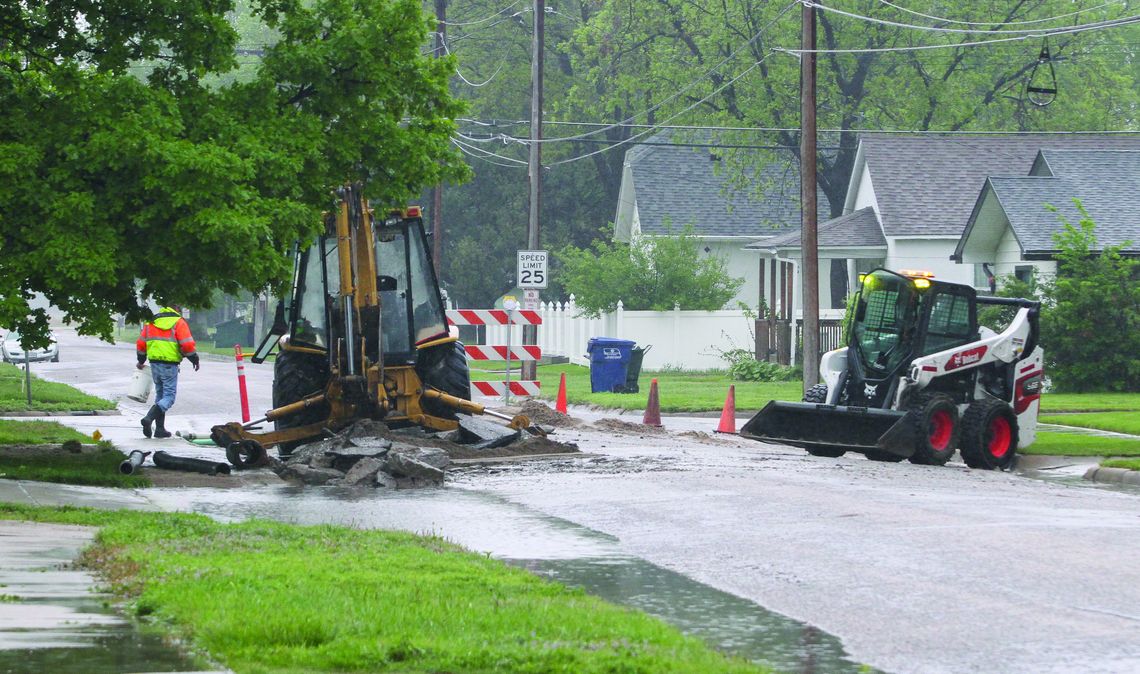 City public works personnel clean up on Monday morning after spending 17 hours repairing a water main leak on 10th Street